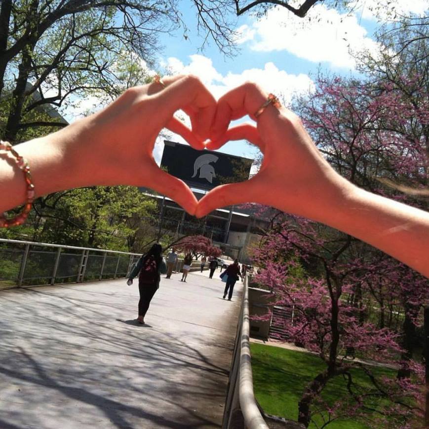 hand heart around spartan logo