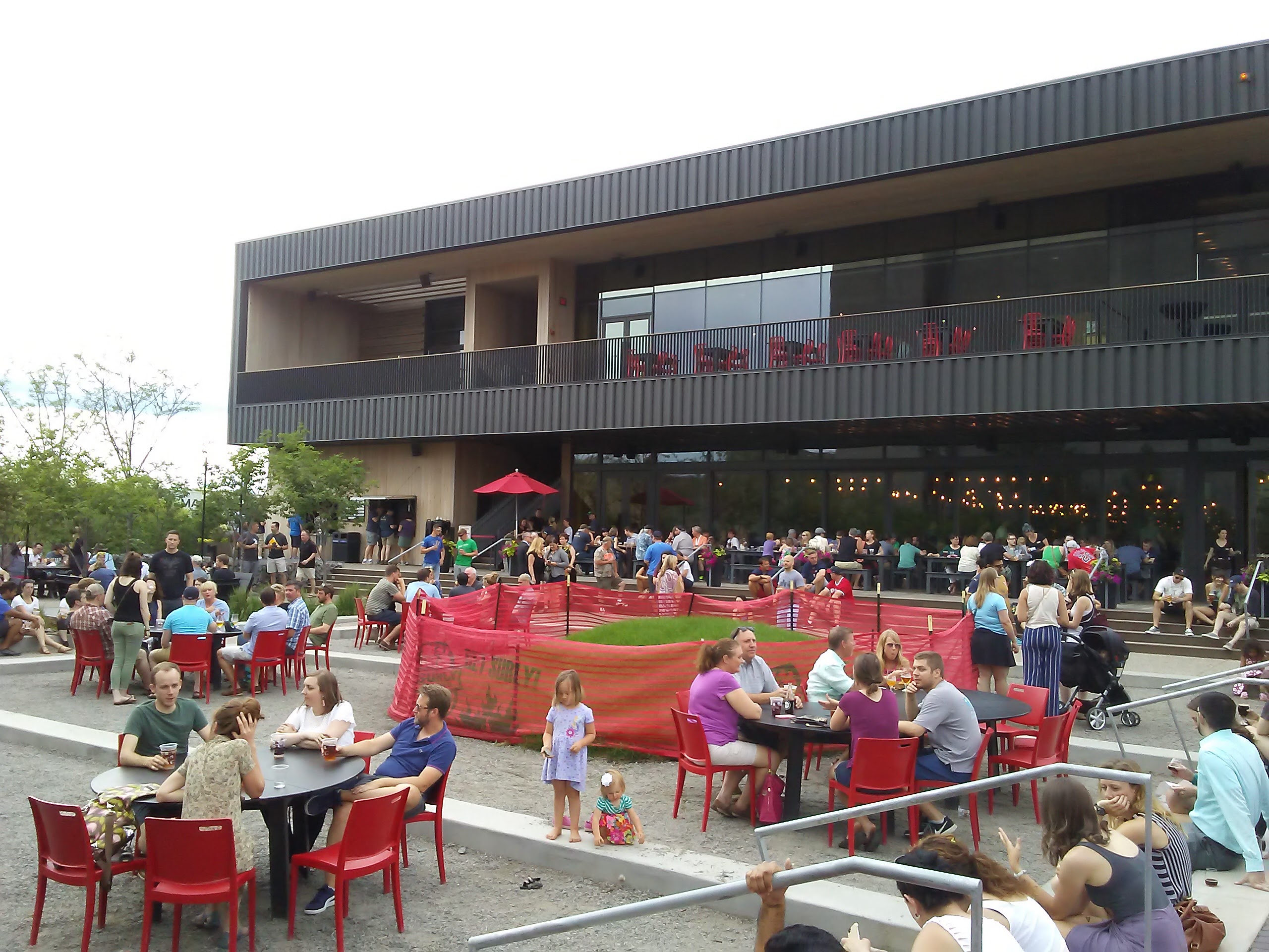 people sitting on large patio at Surly Brewing Company