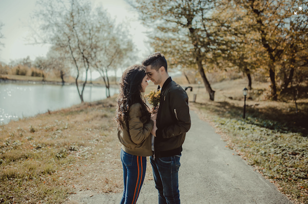 couple pressing foreheads dating in college