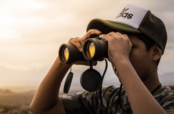 Man looking through binoculars