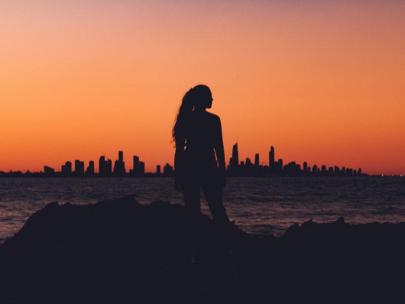 emotional abuse silhouette of girl with sunset and city in bakground