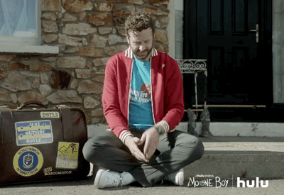 man waiting on bench with suitcase gif