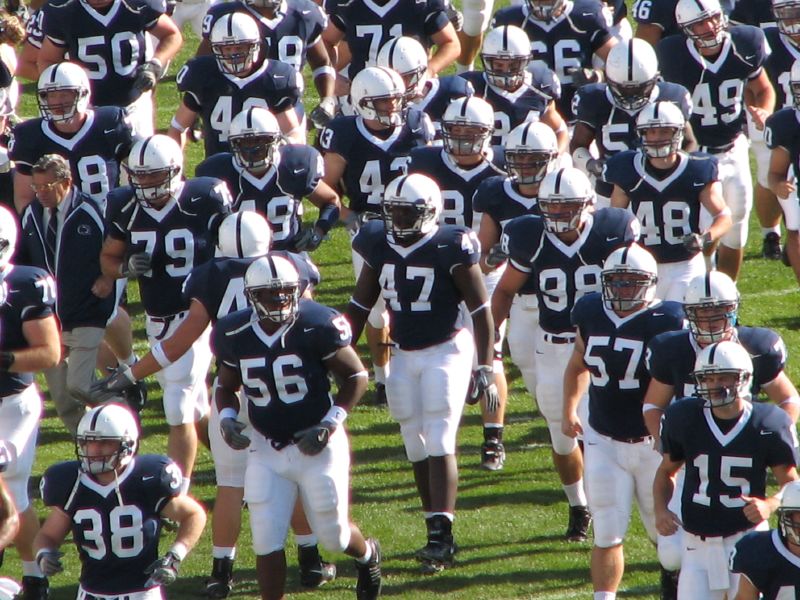 psu football players emerging from the tunnel
