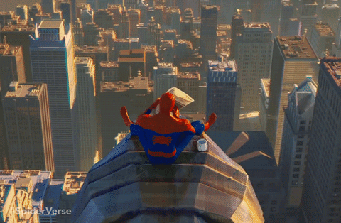 spiderman on top of building reading newspaper gif