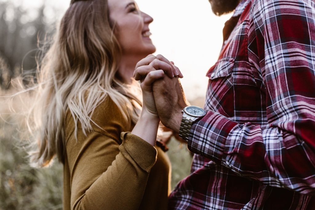 stage 5 clinger couple smiling and holding hands