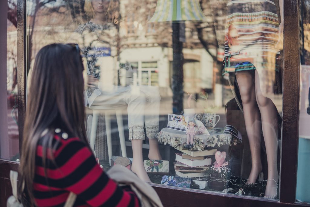 Woman Looking Through Shop Window