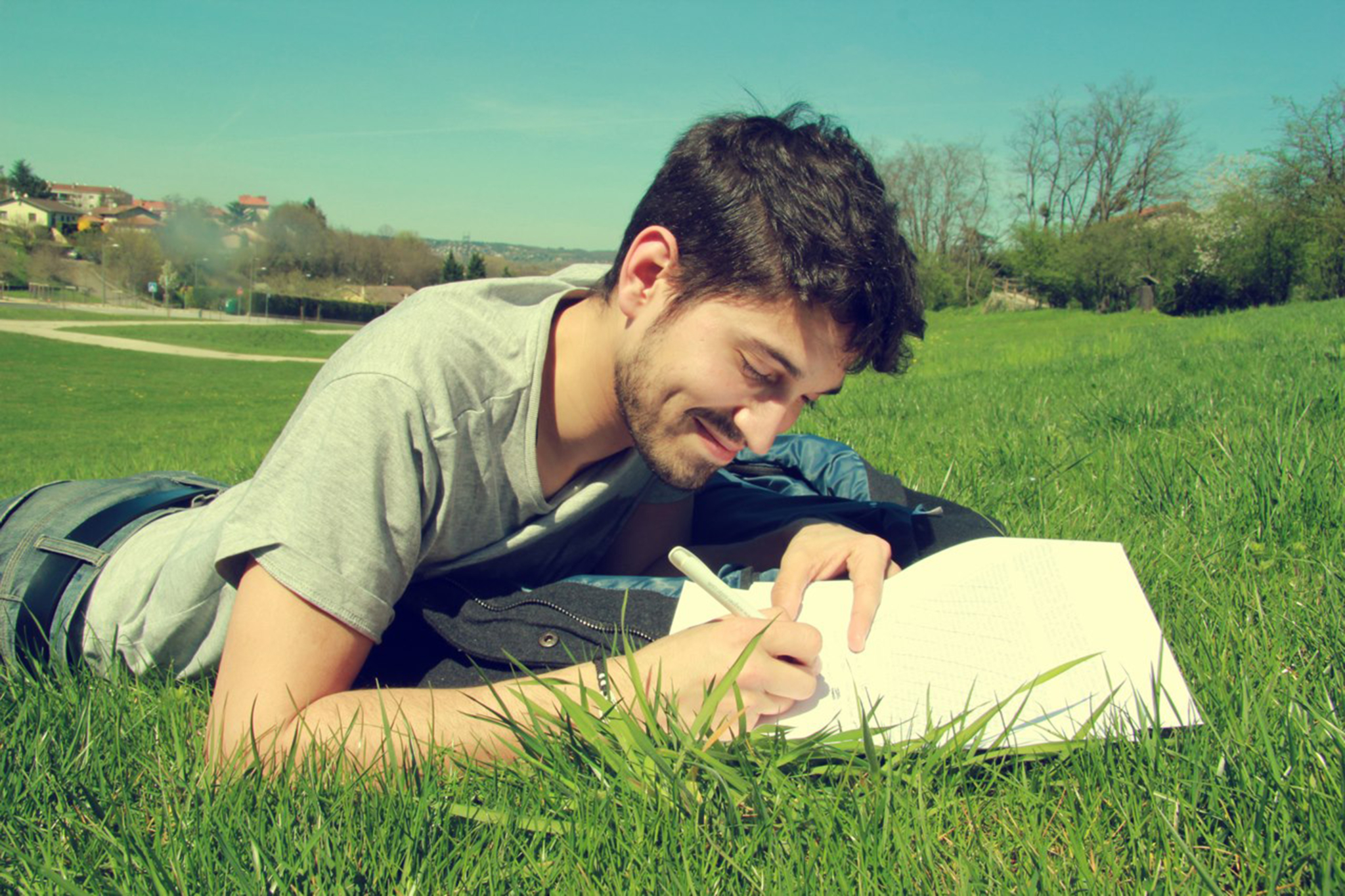 man writing outside