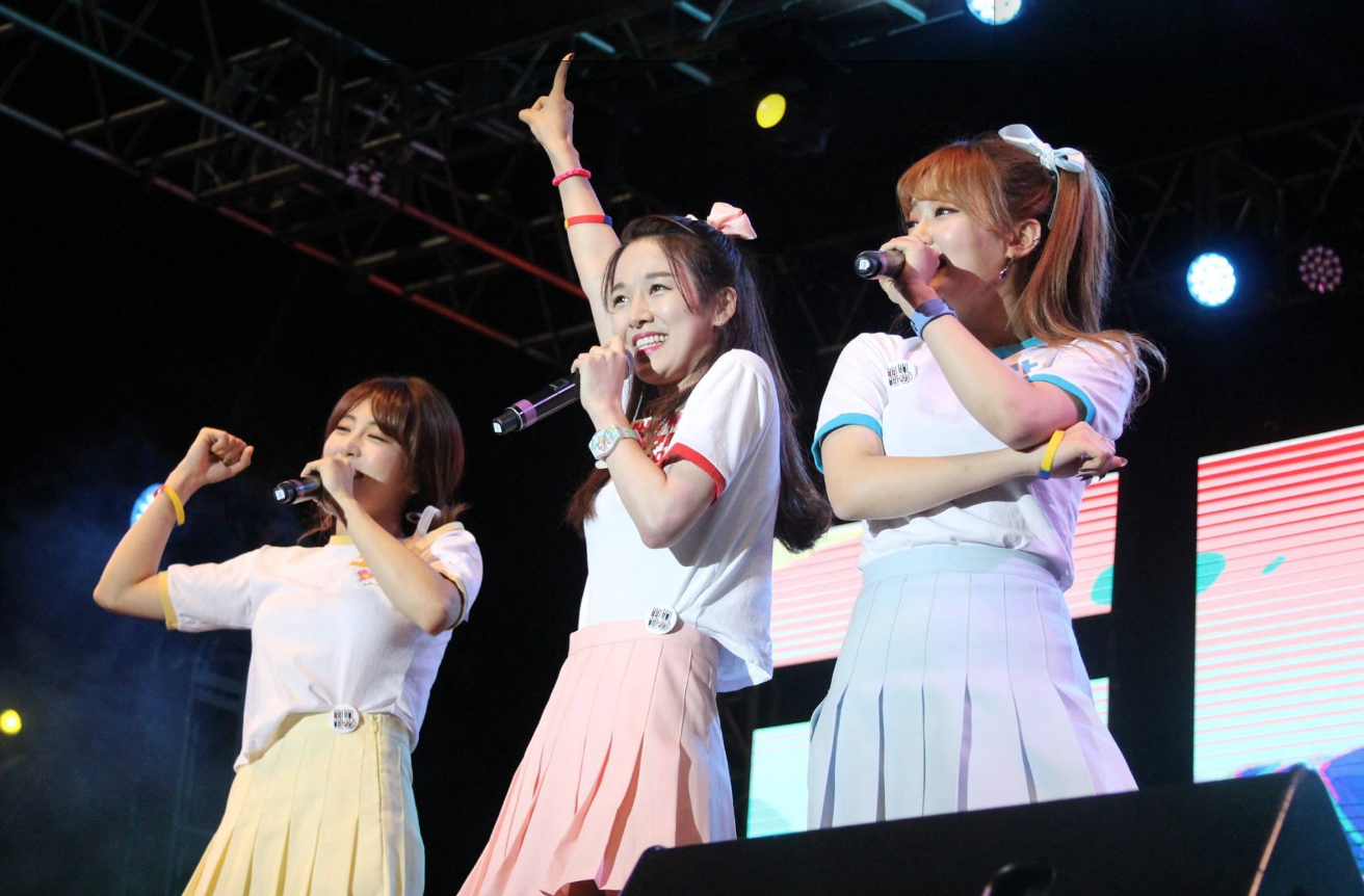 Group of korean pop siingers performing on the main stage at the festival.