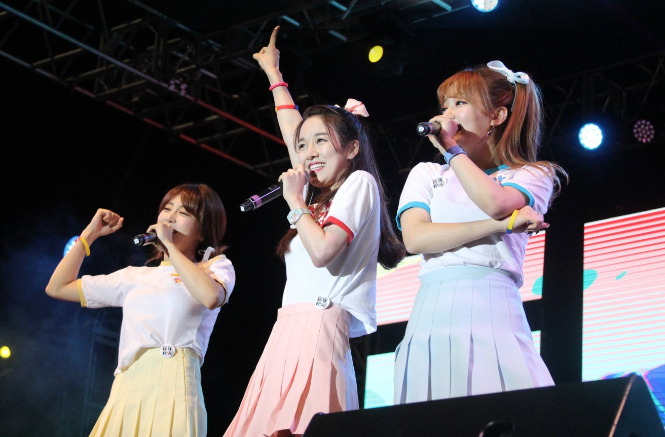 Group of korean pop siingers performing on the main stage at the festival. 