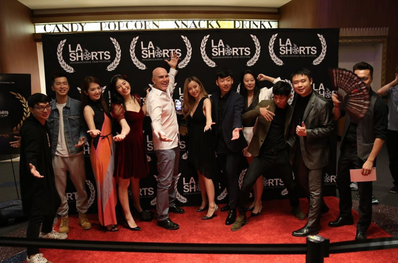 A group of people attend the L.A Shorts Fest and gather together for a picture