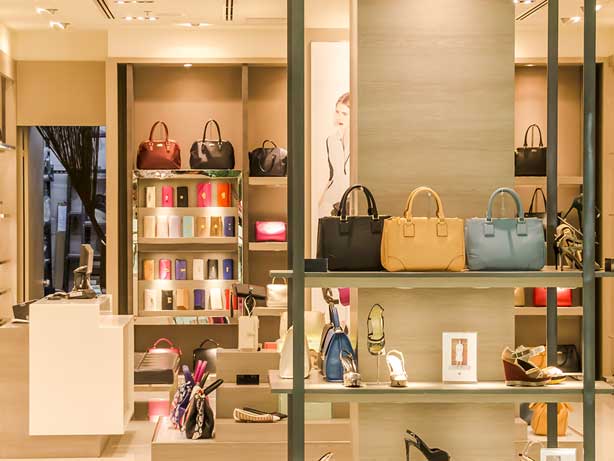 Luxury handbags displayed in store. 