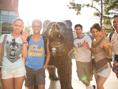 UCLA admitted freshmen standing next to the bruin bear as they pose for a picture