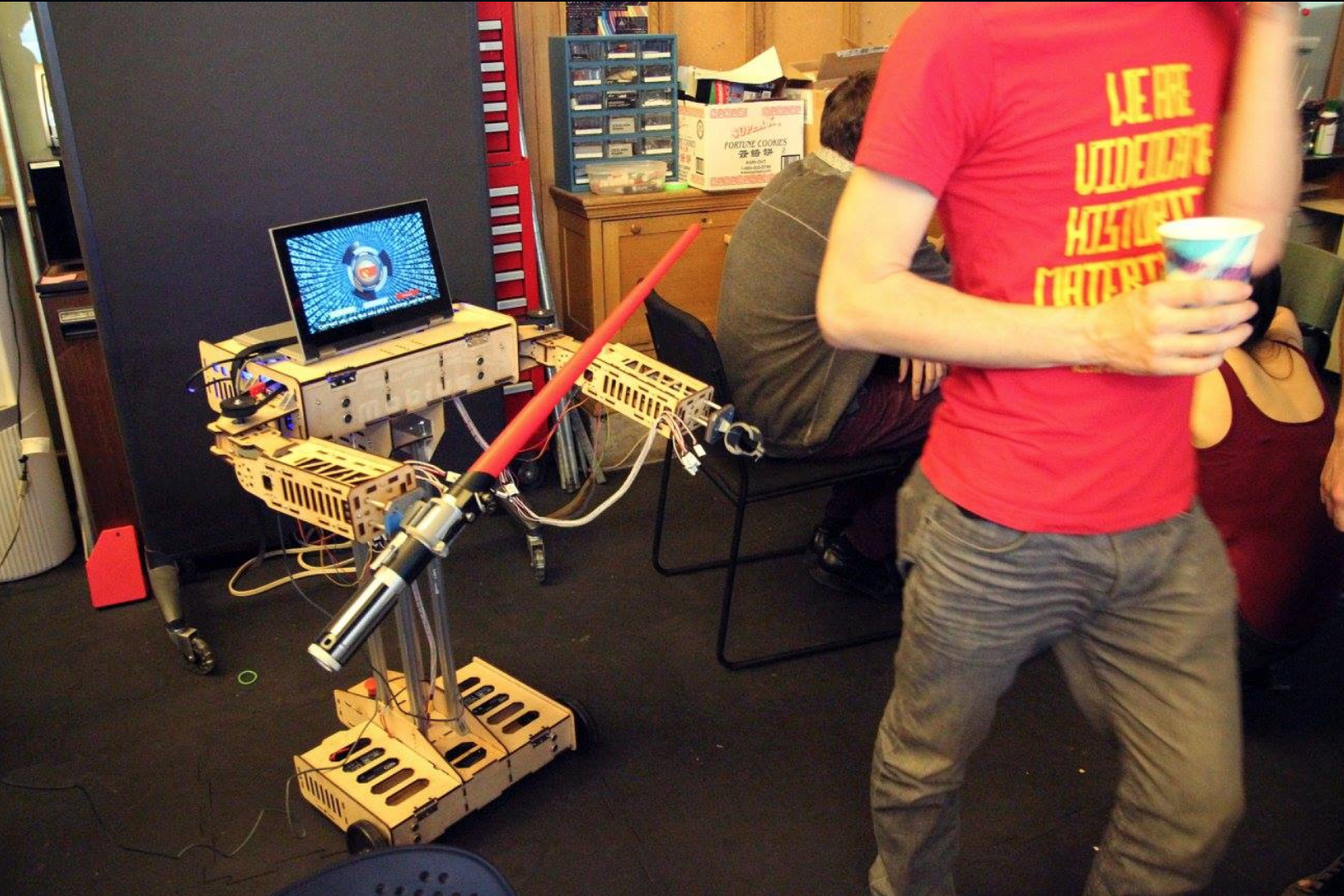 a display of an experimental game design project made of a computer and lightsaber