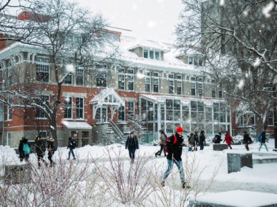 students walking on a snowy campus