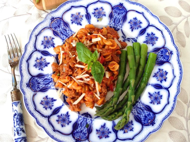 An oriental-patterned plate with an artistic take on beefaroni.