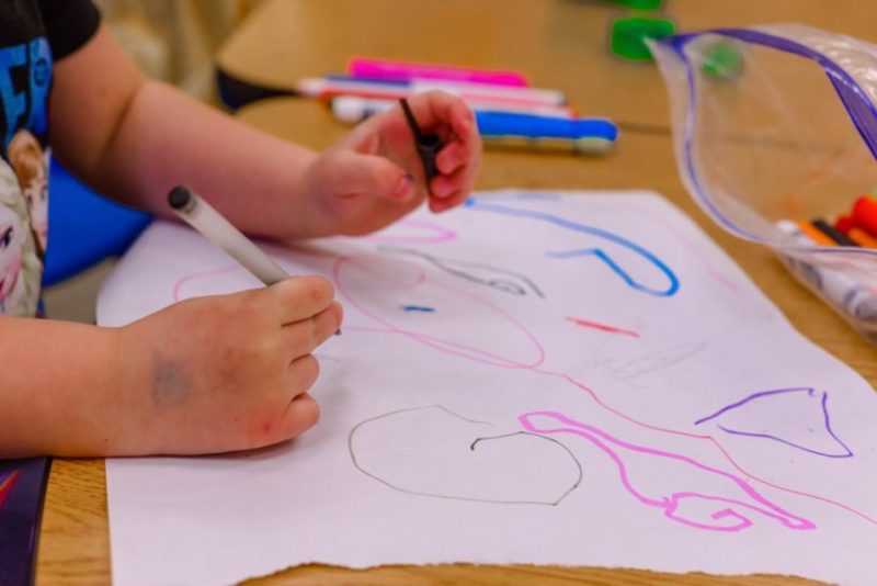 A child works on a drawing in class.