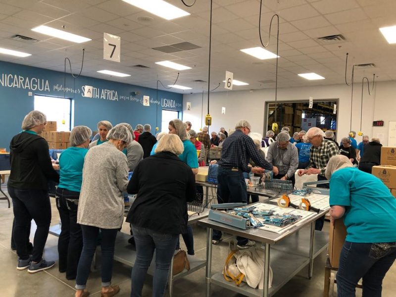 Volunteers package meals