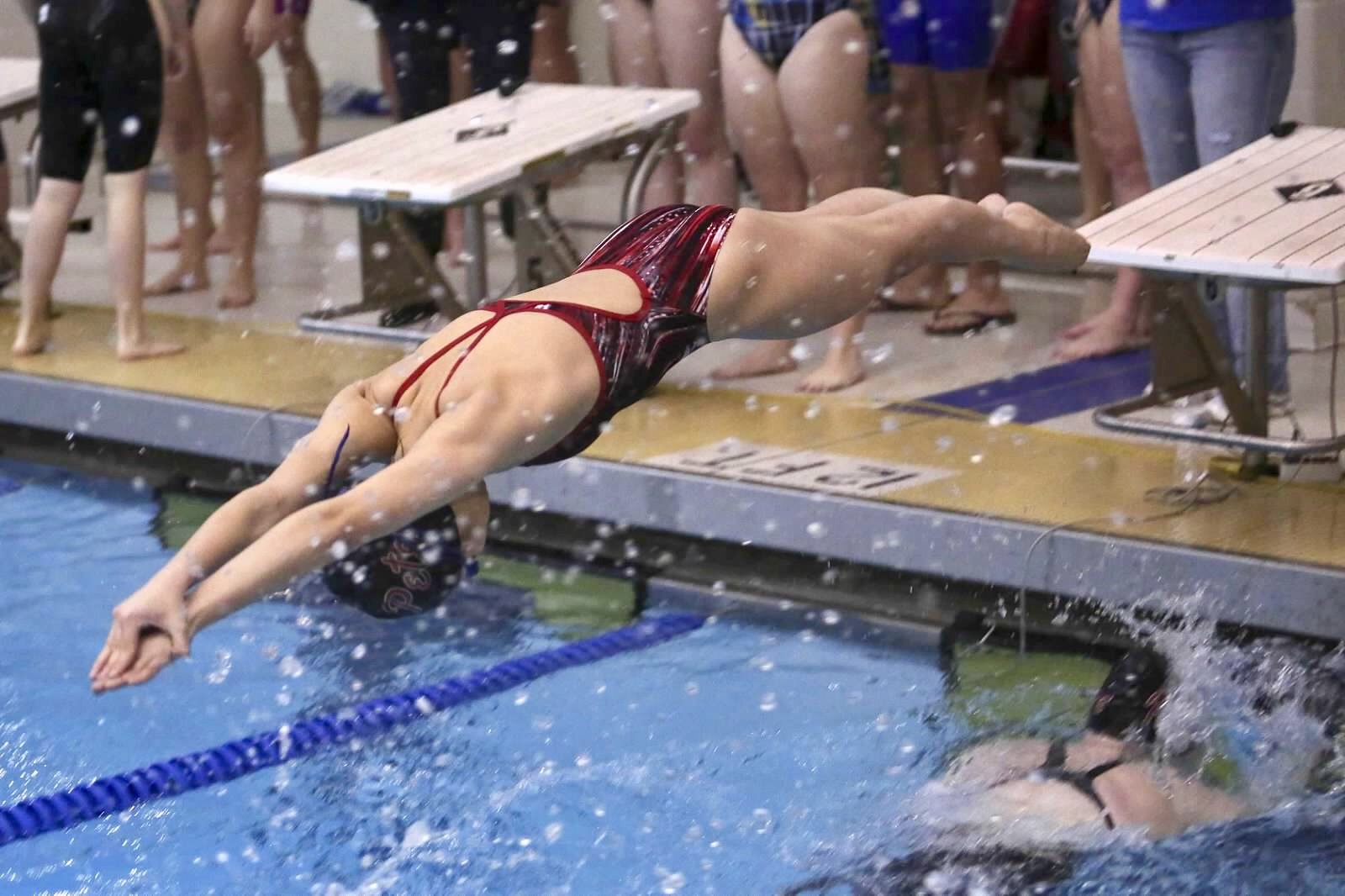 swimmer dives into the water