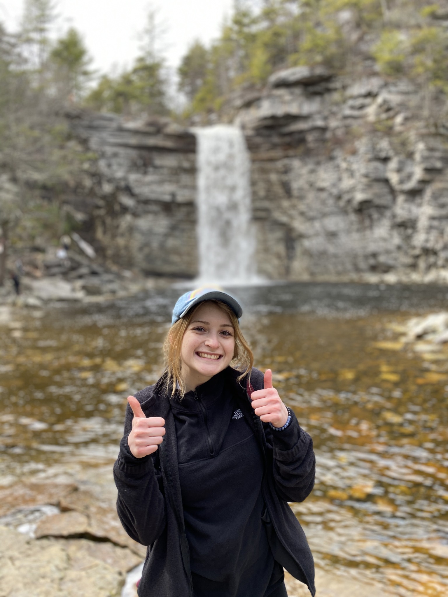 me standing in front of a waterfall, thumbs up!