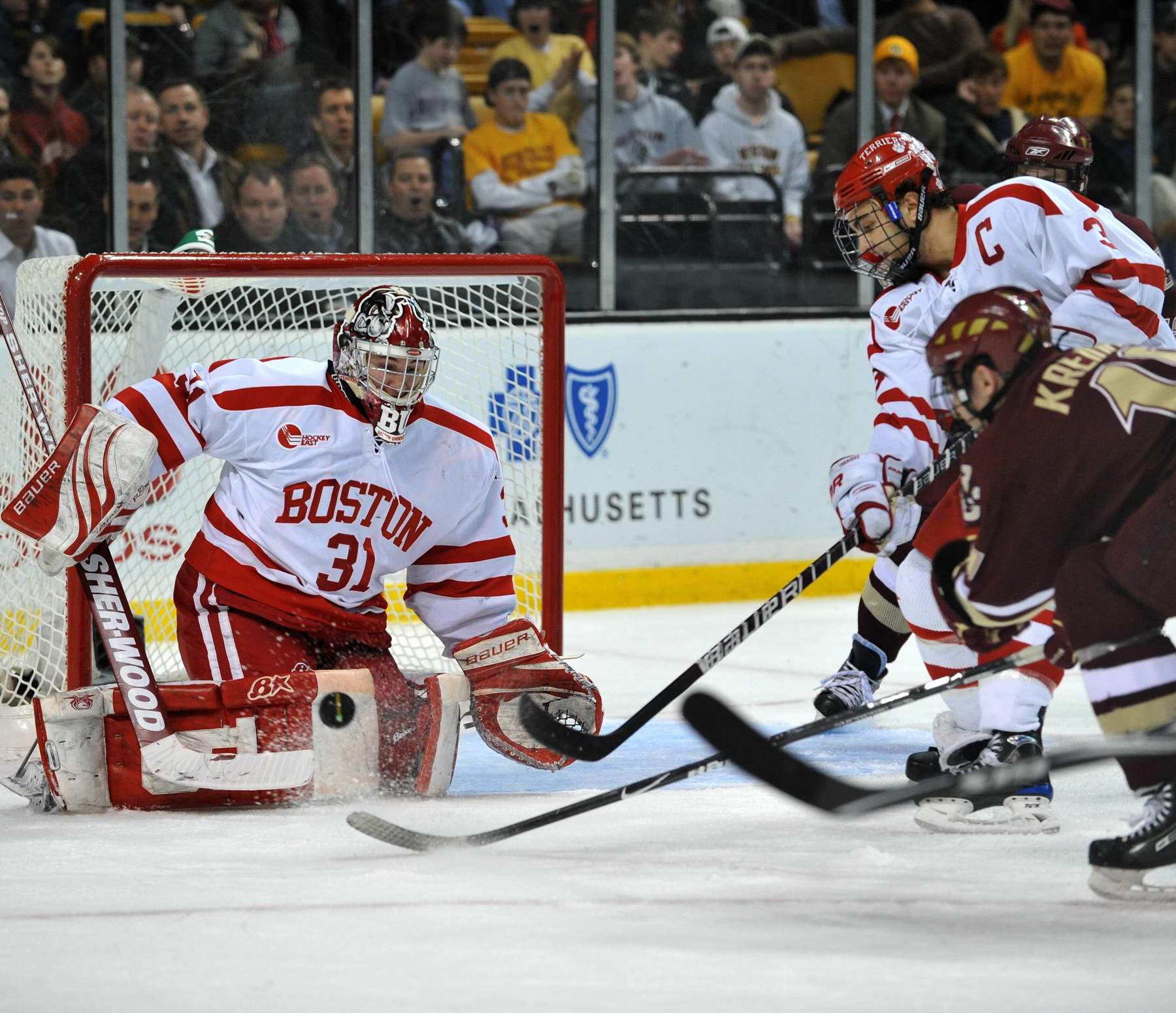 Boston Universitys Hockey goalie defends the goal from Boston College