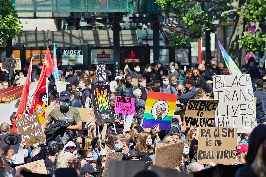 A crowd of people support Pride and Black Lives Matter.