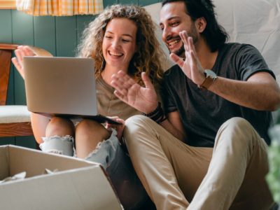 couple on the floor watching their laptop