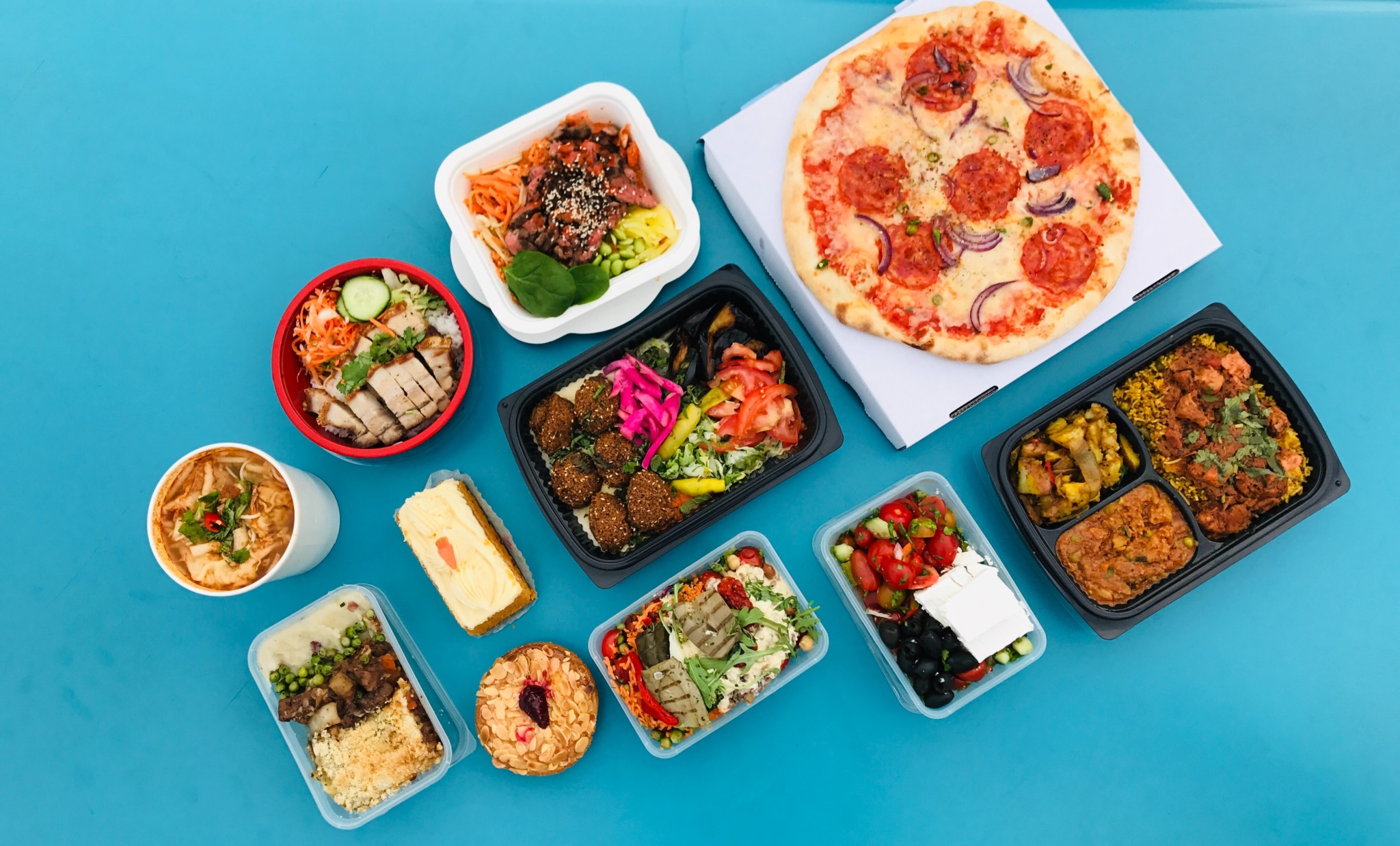 packed lunches spread out on a blue counter