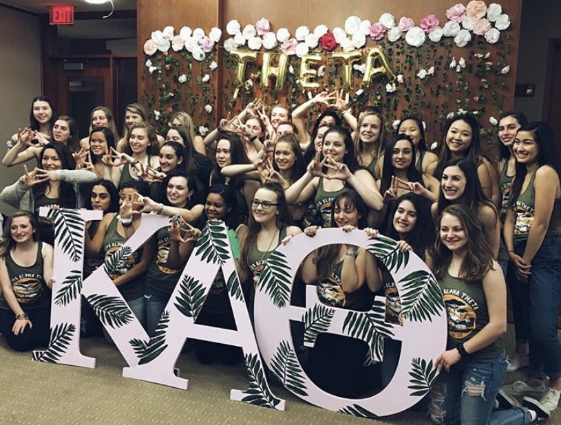 photo of sorority women standing behind the letters KAO