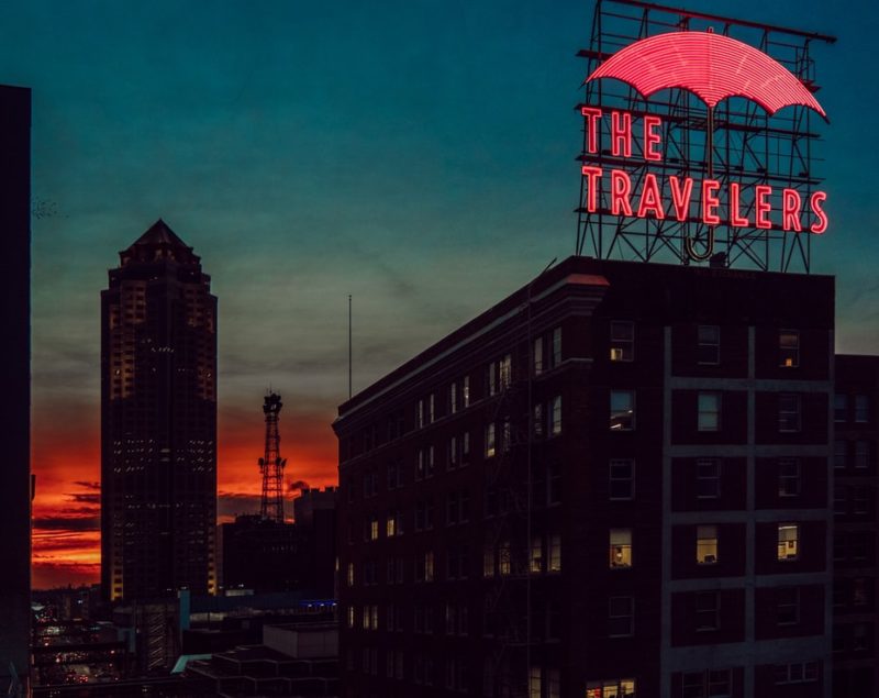 Des Moines Traveler's Sign lights up against the sunset