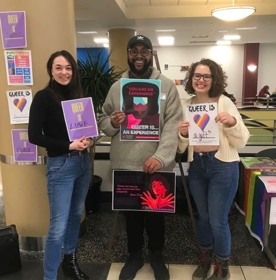 University of Minnesota Twin Cities students pose with LGBTQ related posters
