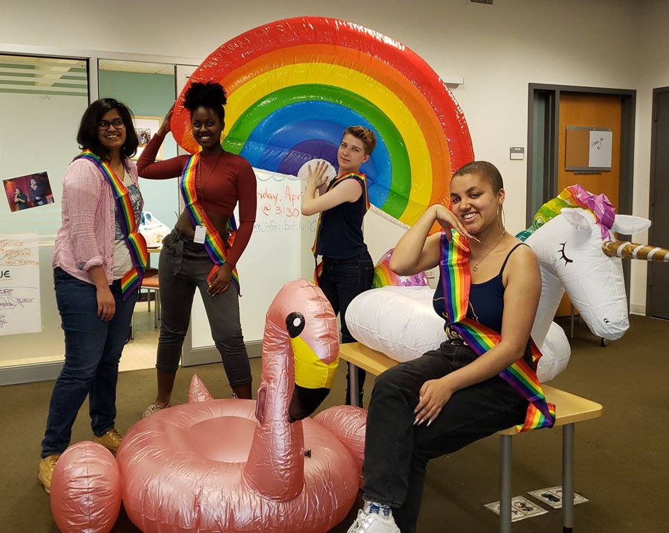 Students pose with rainbow floatie