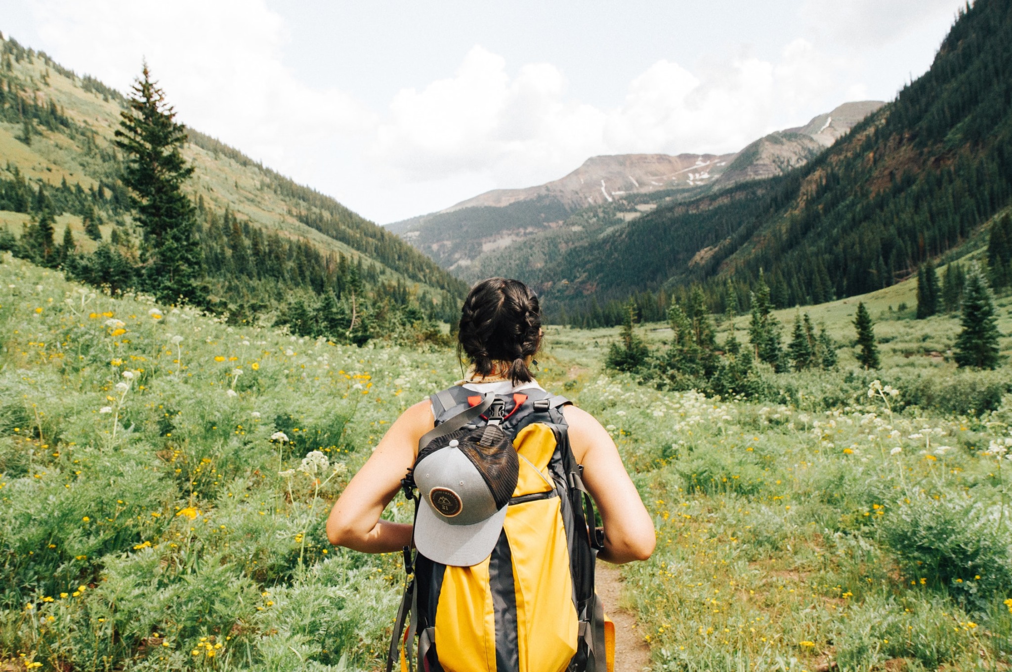 girl hiking staring at an open field