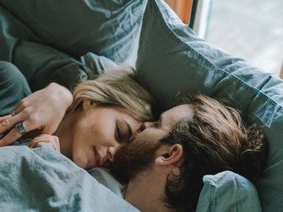 man kissing woman