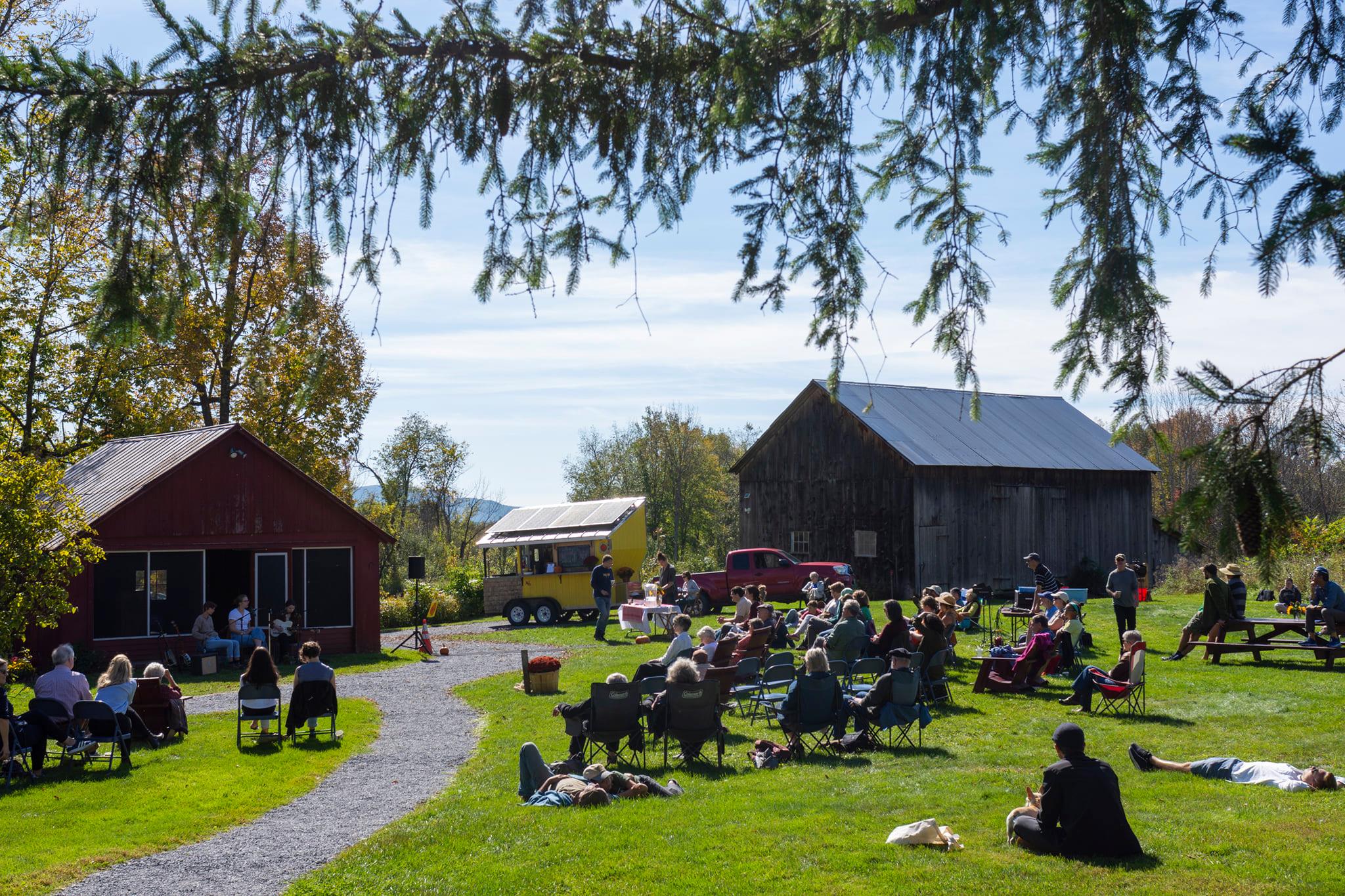 Bennington students on a field by the Robert frost stone house