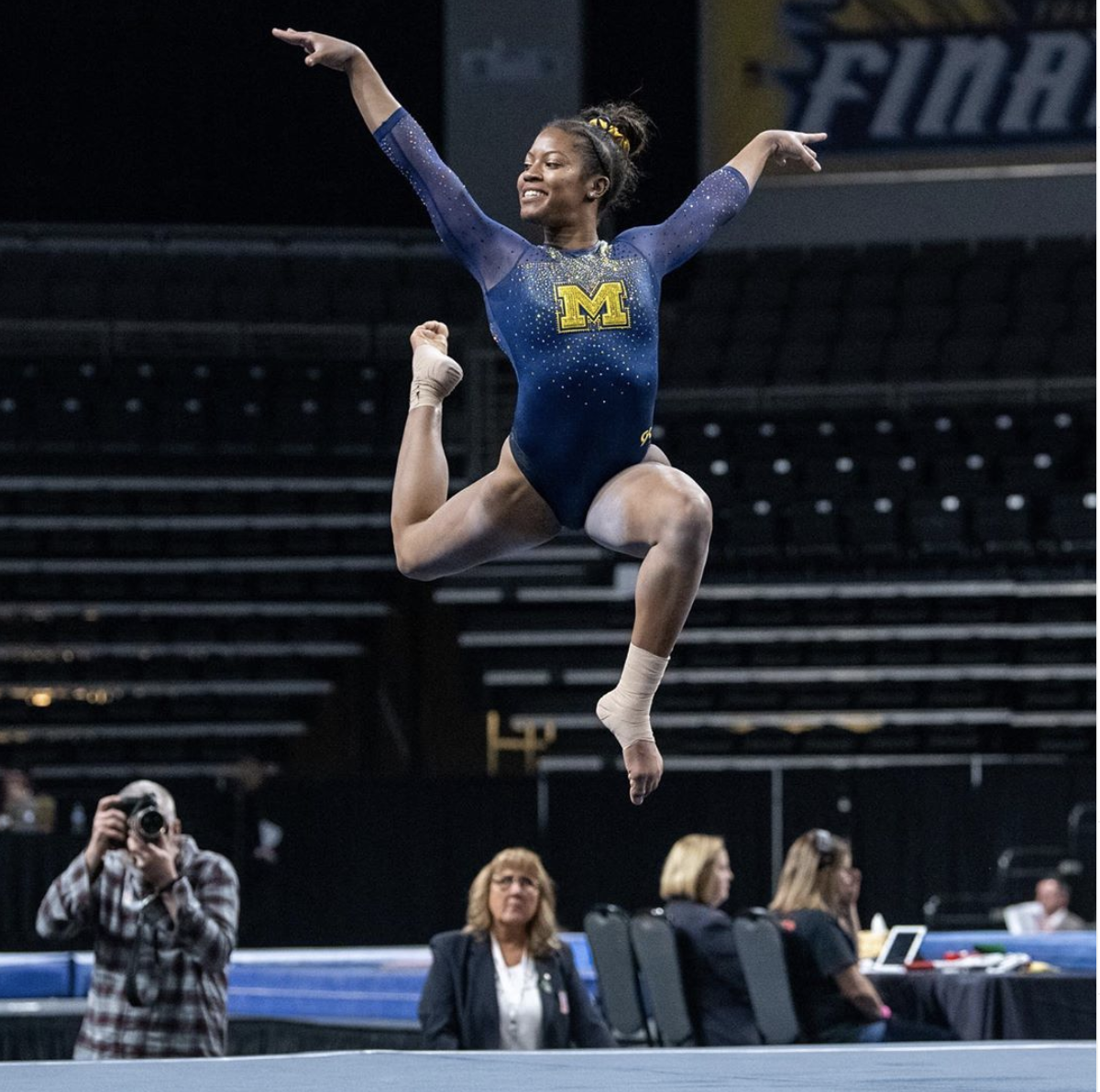 a gymnast jumping on the floor