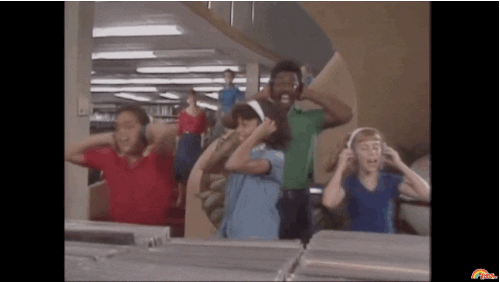 people dancing in library with headphones