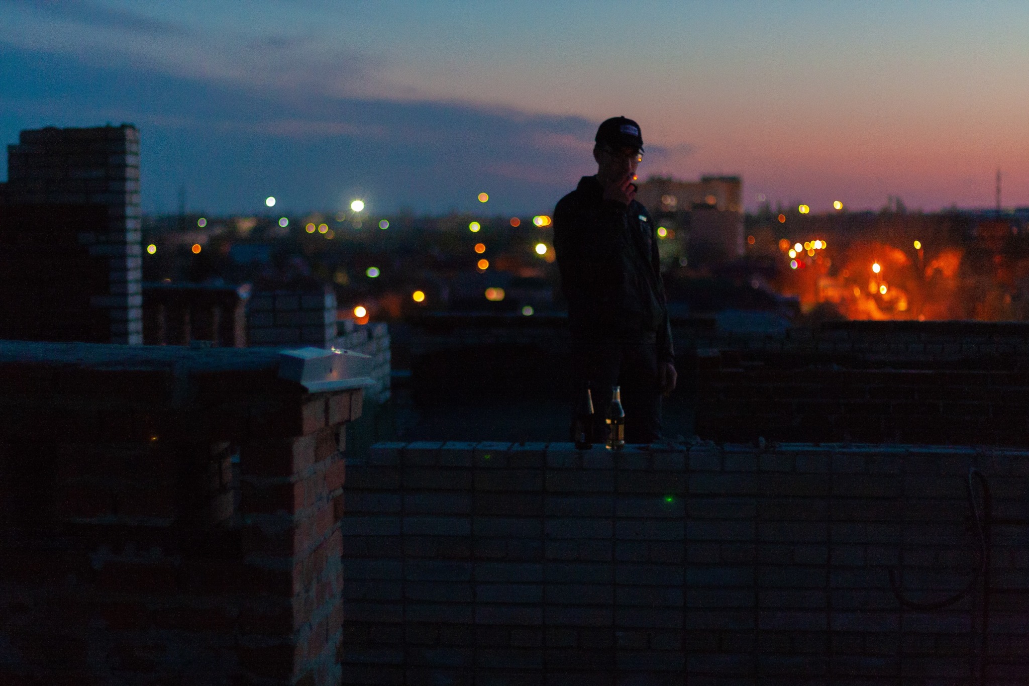 man on roof of building at night