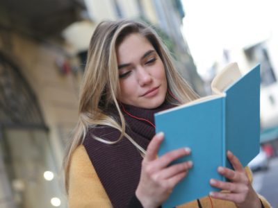 shy student, blonde female reading blue book