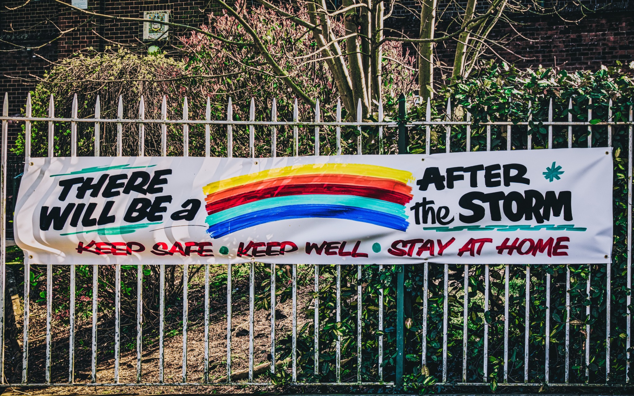 photo of a sign saying "There will be a rainbow after the storm. Keep Safe - Keep Well - Stay At Home