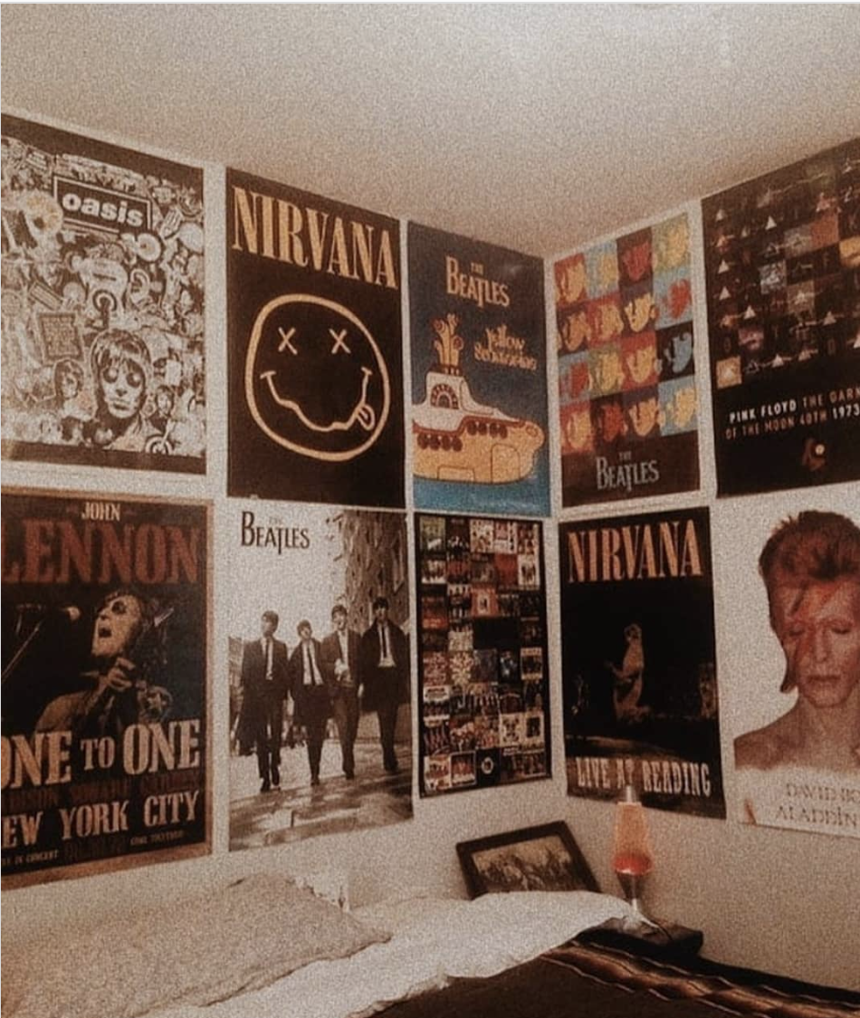 wall of band posters over a bed