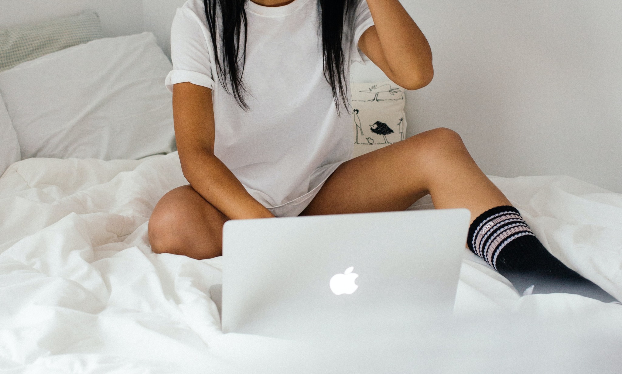 student on computer in bed