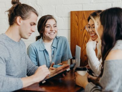 teens sitting together laughing and studying