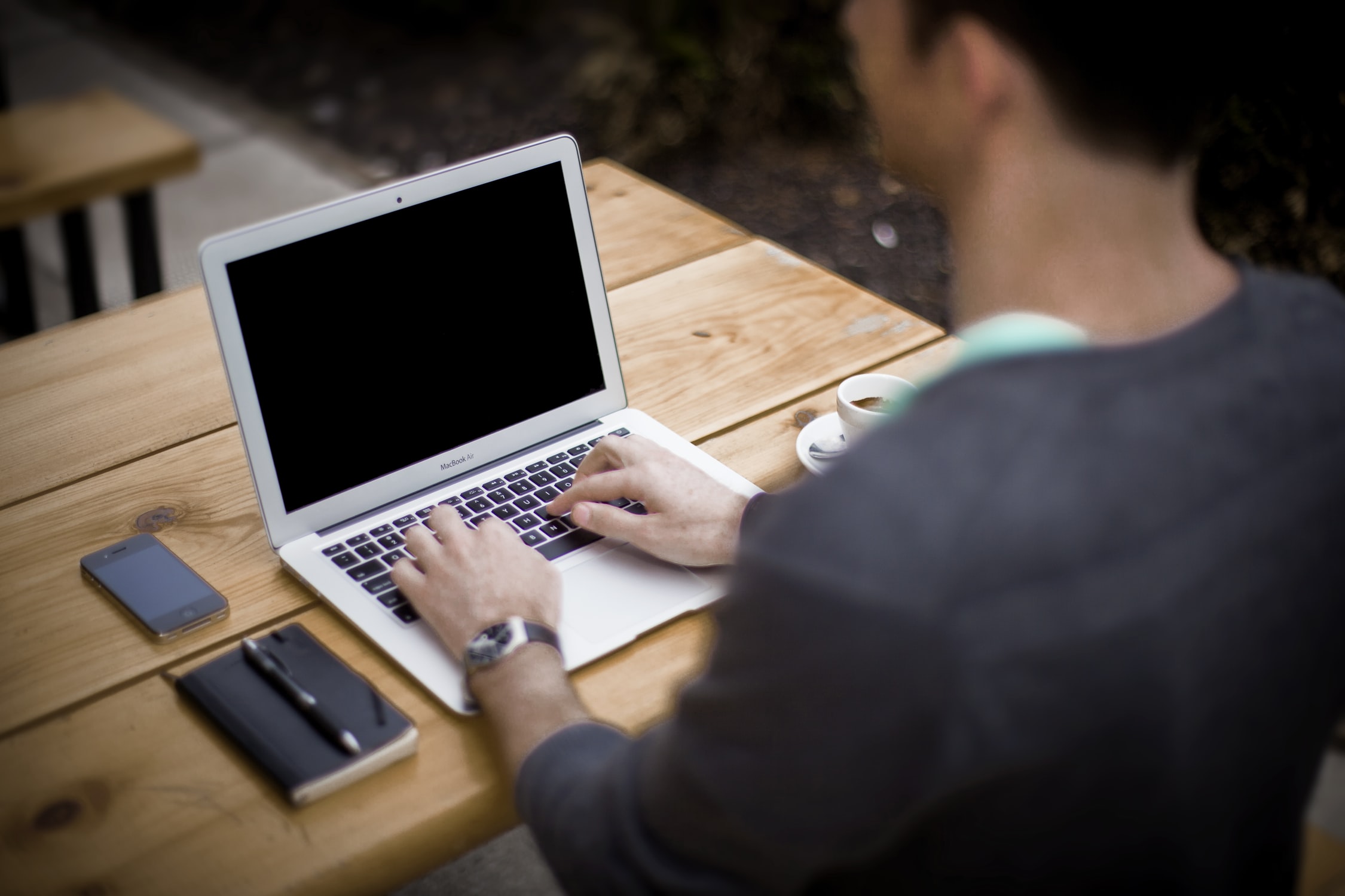 student on a computer outside