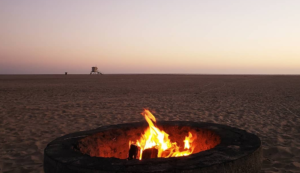 A bonfire burns on the Huntington Beach sand.