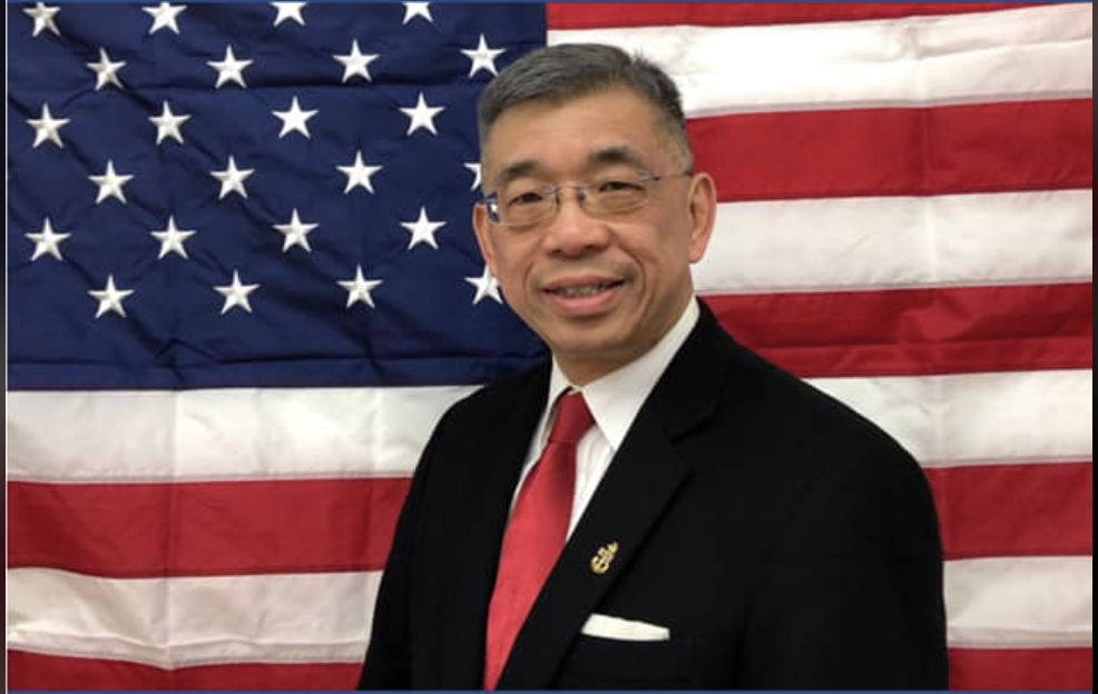 photo of Lester chang and the American flag