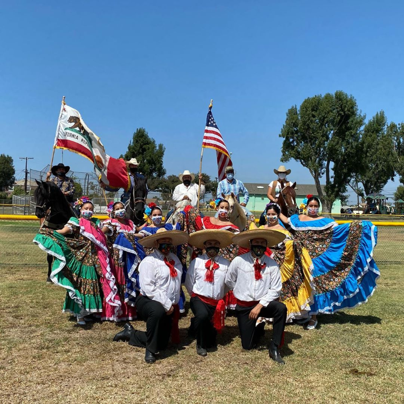 Grupo Folklorico Latinx dancers posing for a picture.