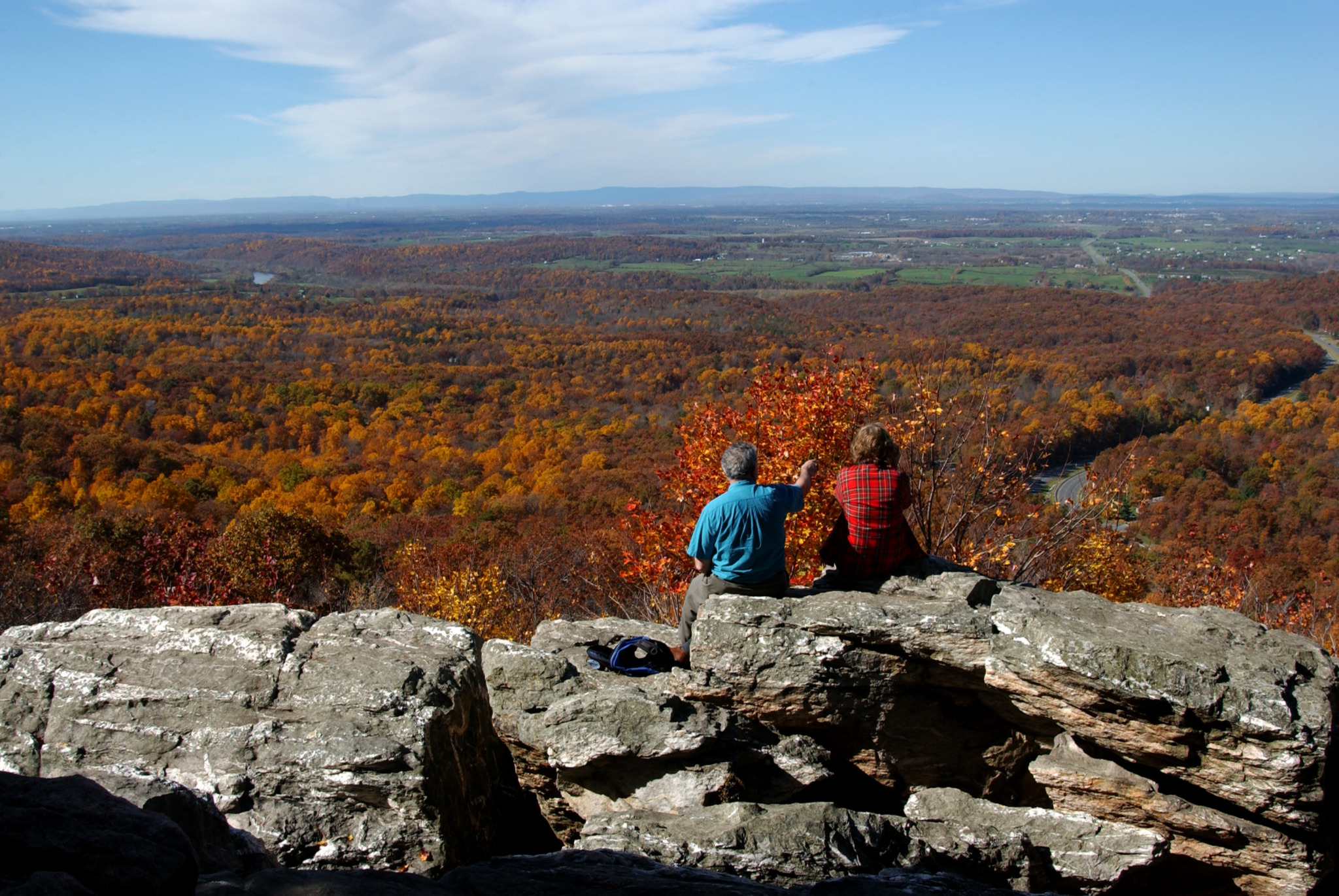 Two people overlooking the Shenandoah Valley in fall