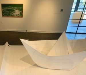 A large paper boat inside an OC art exhibit.