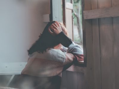 Woman stares out window.