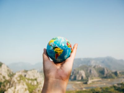 Hand holding a small globe